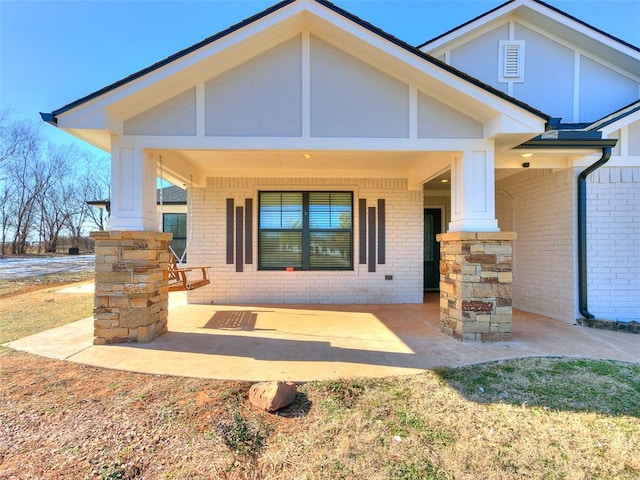 rear view of property with covered porch