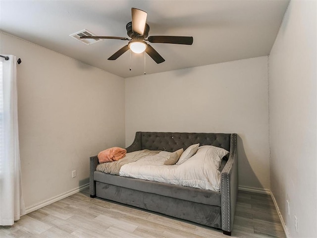 bedroom with ceiling fan and light hardwood / wood-style floors