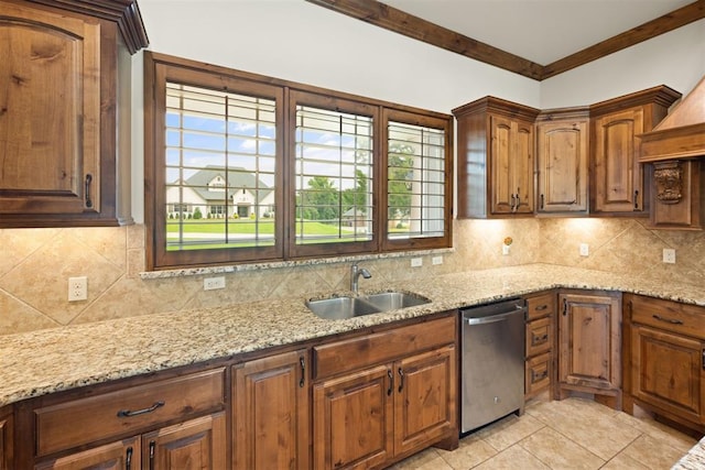 kitchen with sink, tasteful backsplash, dishwasher, and light stone counters