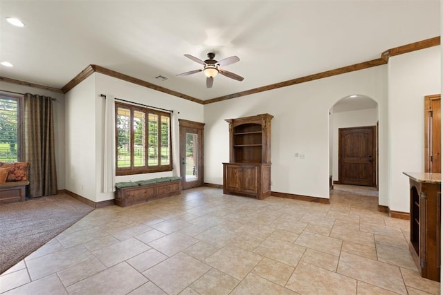 unfurnished living room with light colored carpet, ceiling fan, and crown molding