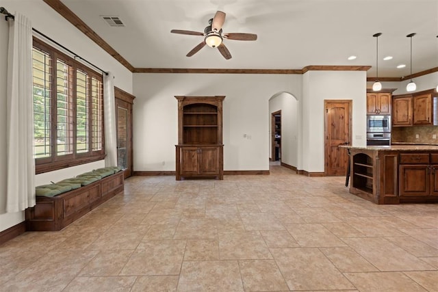 unfurnished living room with ceiling fan, crown molding, and light tile patterned floors