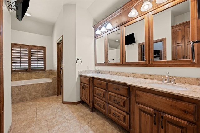 bathroom featuring vanity, tiled tub, and tile patterned floors