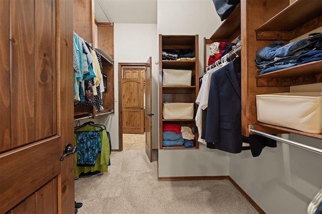 spacious closet featuring light colored carpet