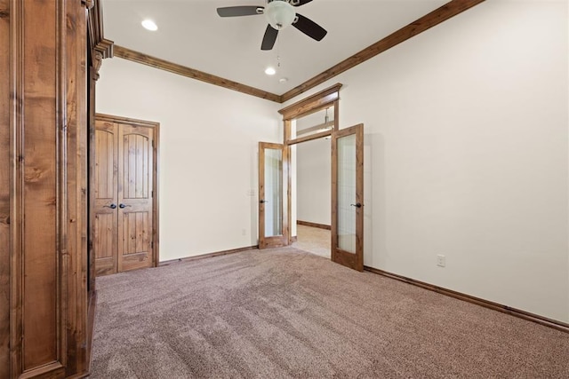 unfurnished bedroom with ceiling fan, french doors, ornamental molding, and carpet floors