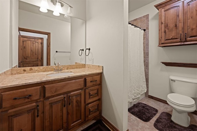 bathroom featuring toilet, vanity, and a shower with curtain