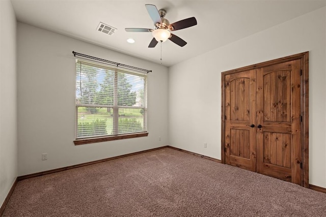 unfurnished bedroom featuring ceiling fan and carpet