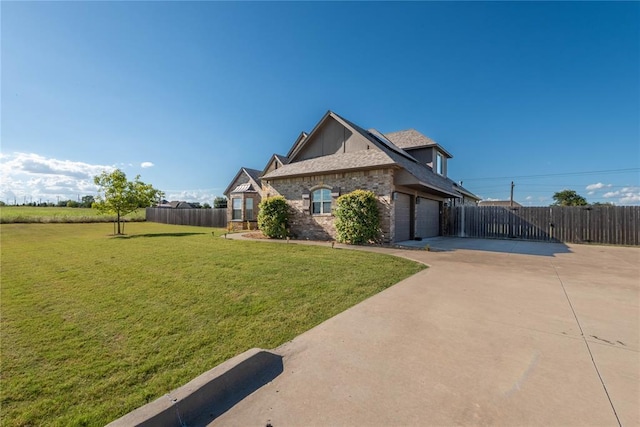 view of side of property featuring a lawn and a garage