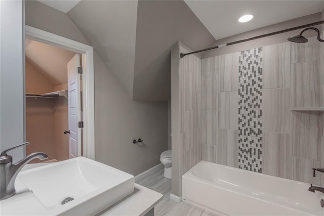 full bathroom featuring sink, lofted ceiling, hardwood / wood-style flooring, toilet, and shower / bathtub combination