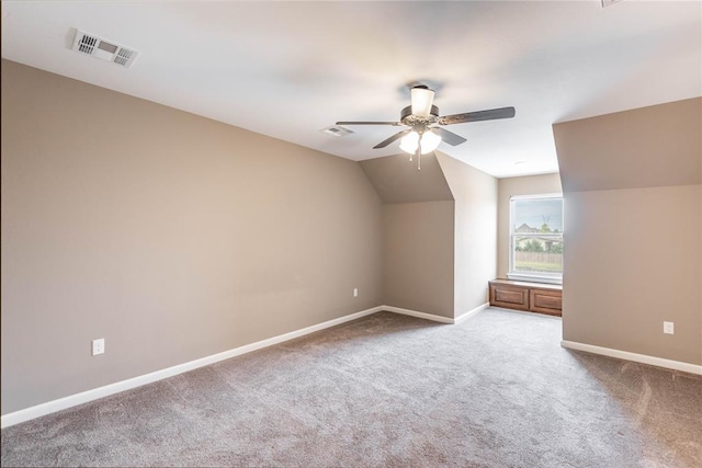 additional living space with carpet flooring, ceiling fan, and vaulted ceiling