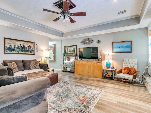 living room featuring ceiling fan, crown molding, and hardwood / wood-style flooring