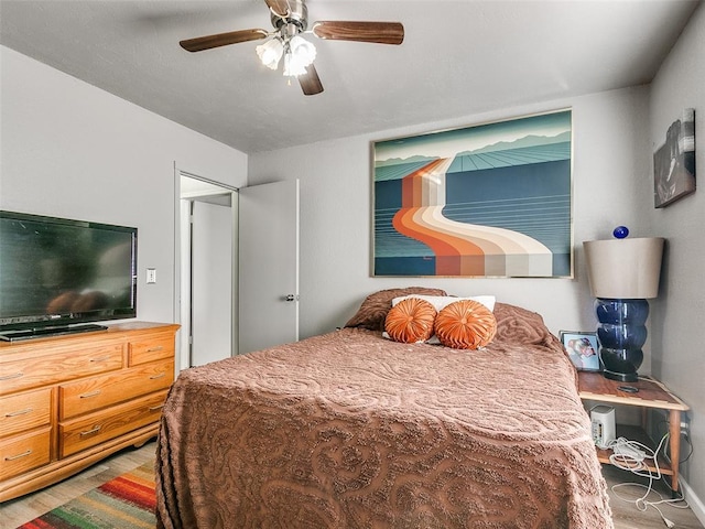 bedroom featuring ceiling fan and hardwood / wood-style flooring