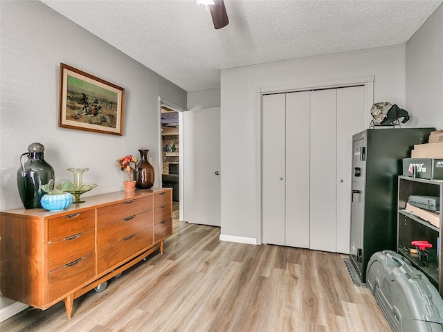 interior space featuring a textured ceiling, ceiling fan, and light hardwood / wood-style flooring