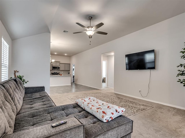 carpeted living room with ceiling fan