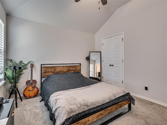 carpeted bedroom featuring ceiling fan and lofted ceiling