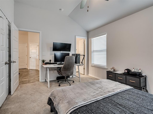 carpeted bedroom featuring ceiling fan and vaulted ceiling