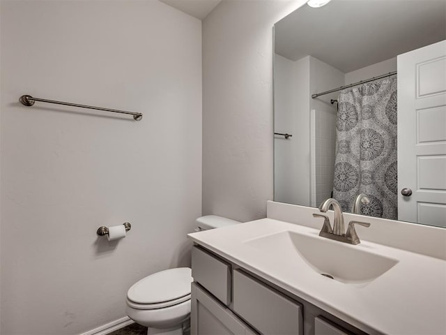 bathroom with toilet, vanity, and a shower with curtain