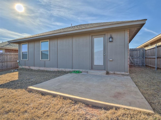 back of property with a patio