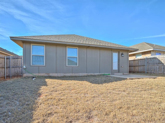 rear view of property featuring a patio area and a yard