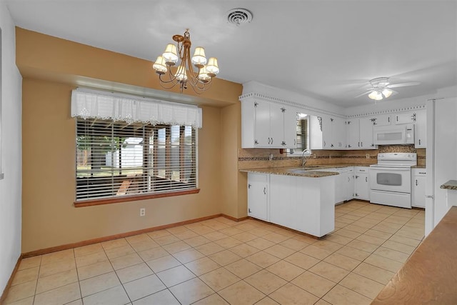 kitchen with ceiling fan with notable chandelier, white appliances, white cabinetry, tasteful backsplash, and light tile patterned floors