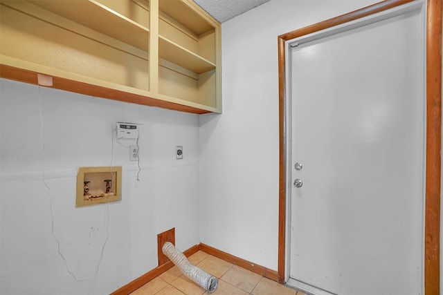 clothes washing area featuring a textured ceiling, light tile patterned floors, hookup for a washing machine, and hookup for an electric dryer