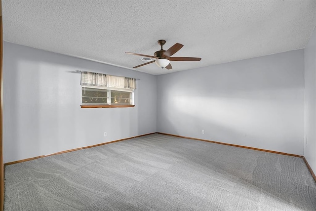 carpeted empty room featuring ceiling fan and a textured ceiling