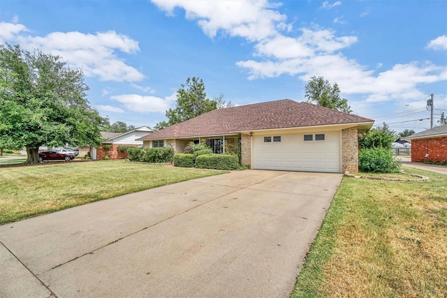 single story home with a garage and a front lawn