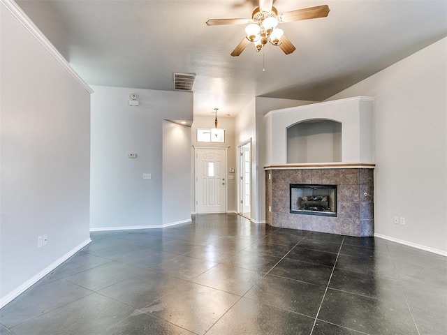 unfurnished living room featuring ceiling fan and a tile fireplace