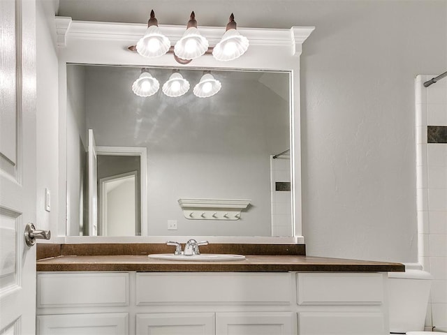 bathroom featuring vanity and tiled shower / bath