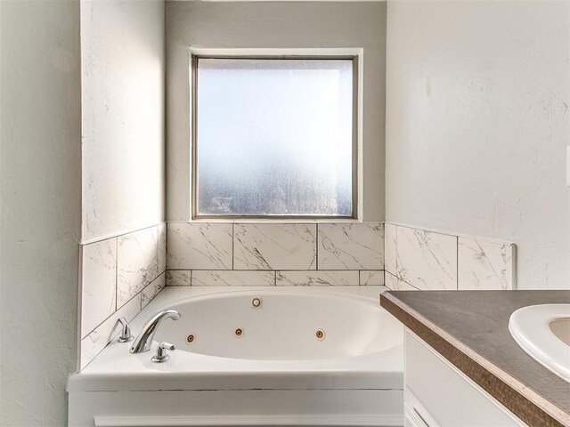 bathroom featuring vanity and a bathing tub