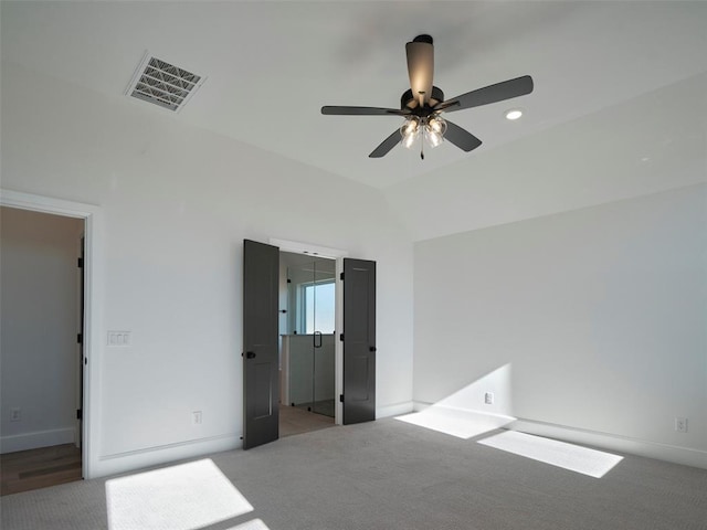 unfurnished bedroom featuring carpet, ceiling fan, and vaulted ceiling