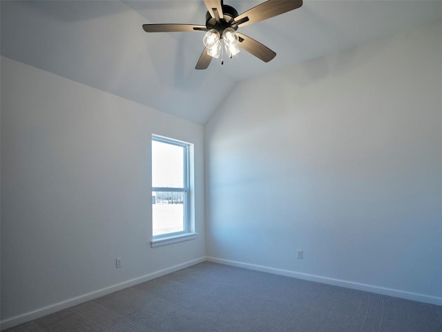 unfurnished room with lofted ceiling, ceiling fan, and dark carpet