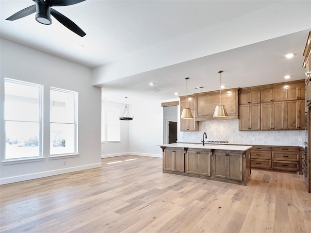 9116 SW 92nd St, Mustang, OK 73064 - kitchen featuring decorative backsplash, baseboards, light wood finished floors, light countertops, and ceiling fan