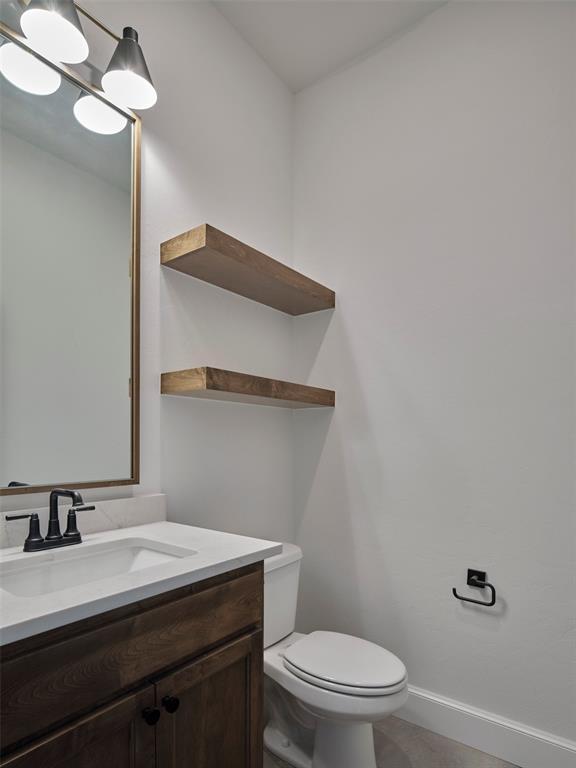 9116 SW 92nd St, Mustang, OK 73064 - bathroom featuring vanity, toilet, and baseboards