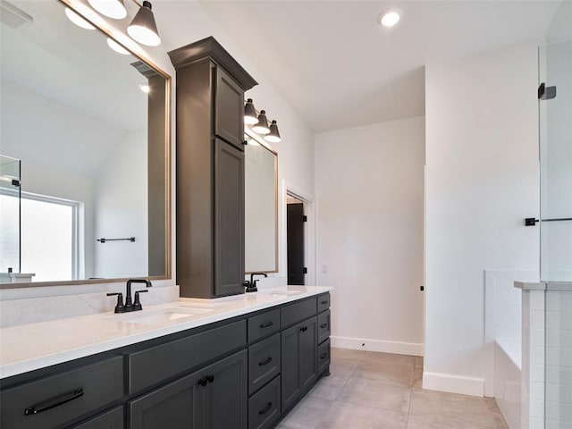 9116 SW 92nd St, Mustang, OK 73064 - bathroom featuring double vanity, a bathtub, baseboards, tile patterned flooring, and recessed lighting