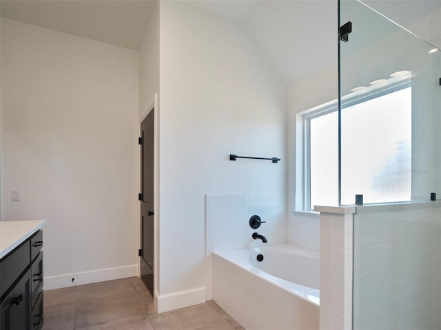 9116 SW 92nd St, Mustang, OK 73064 - full bath featuring vanity, a garden tub, tile patterned floors, baseboards, and lofted ceiling