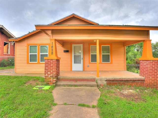 bungalow featuring a porch and a front yard