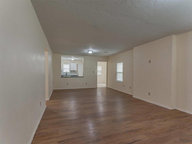 unfurnished room with dark hardwood / wood-style flooring