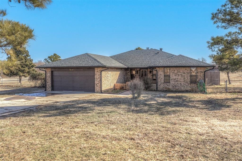 view of front of home with a front lawn and a garage