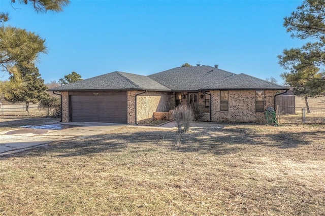 view of front of home with a front lawn and a garage