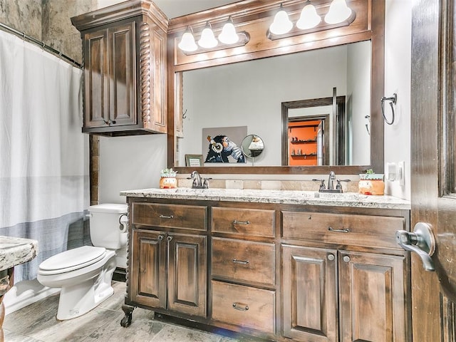 bathroom with toilet, vanity, and a shower with curtain