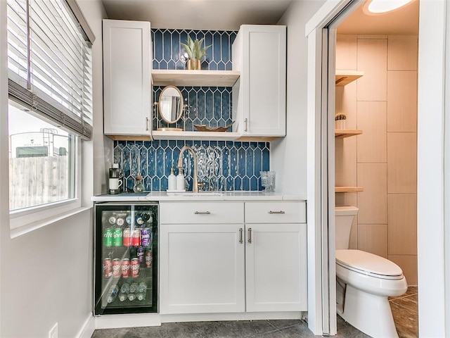 bar featuring white cabinets, tile patterned flooring, wine cooler, and sink