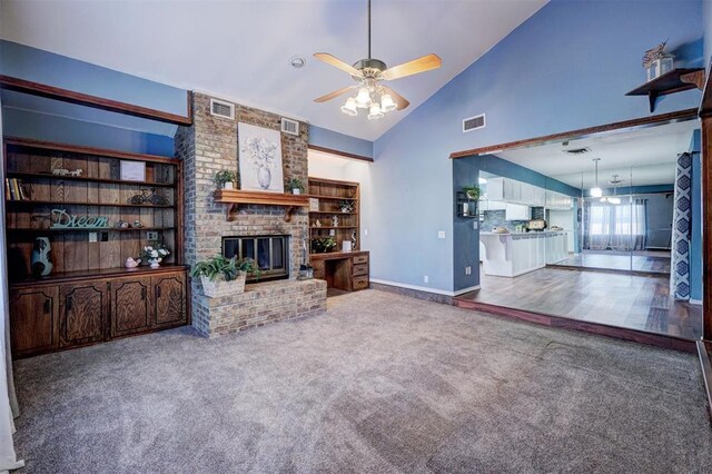 unfurnished living room with carpet floors, ceiling fan, visible vents, and a brick fireplace
