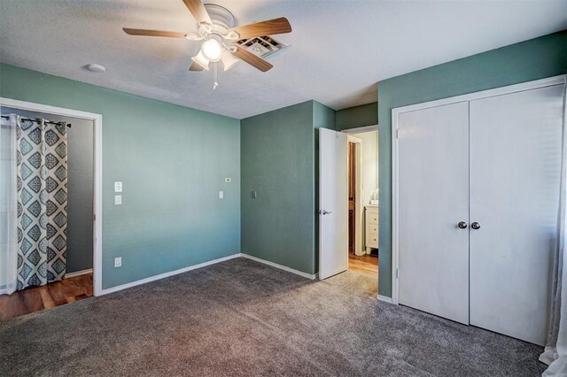 unfurnished bedroom with a ceiling fan, baseboards, visible vents, and carpet
