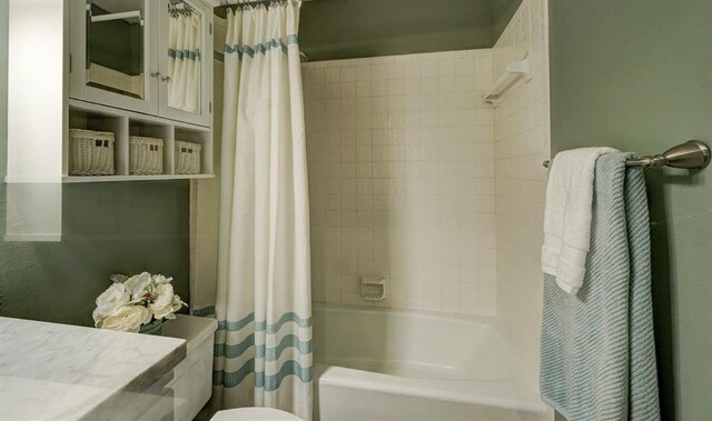 full bathroom featuring toilet and shower / bath combination with curtain