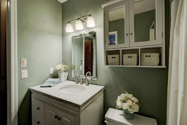 full bathroom featuring vanity and toilet