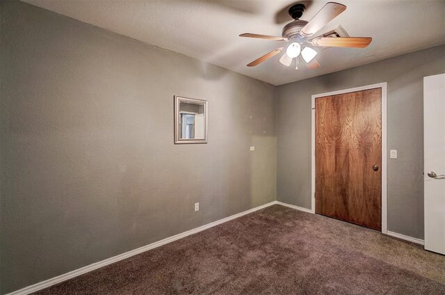 unfurnished bedroom with a closet, carpet floors, baseboards, and a ceiling fan