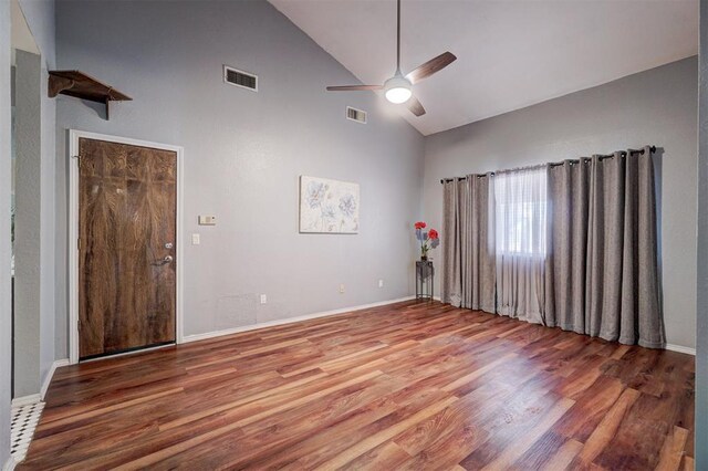 unfurnished room featuring high vaulted ceiling, ceiling fan, wood finished floors, and visible vents