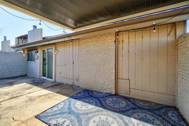 property entrance with a patio and a chimney