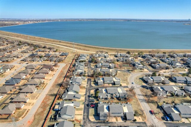 birds eye view of property featuring a water view and a residential view