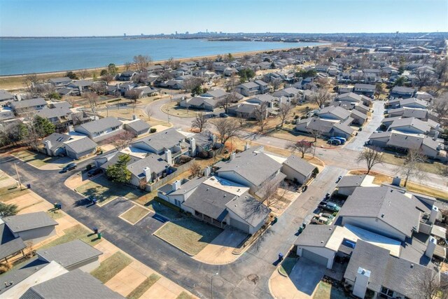 birds eye view of property featuring a water view and a residential view